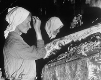 Женщины молятся перед иконой Святого Петра и Павла в католическом соборе.